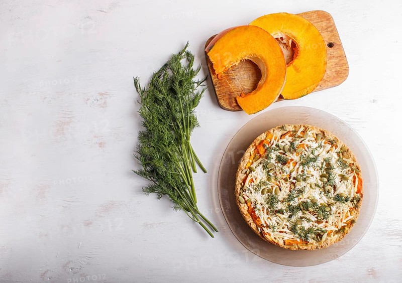 Sweet pumpkin pie with cheese and dill on white wooden background. top view. copy space