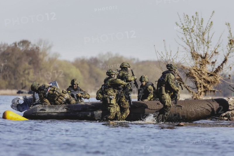 Czech and German soldiers launch an inflatable boat into the Elbe as part of the military exercise 'Wettiner Schwert' near Tangermünde, 26 March 2024. 'Wettiner Schwert' is part of the NATO Quadriga exercise