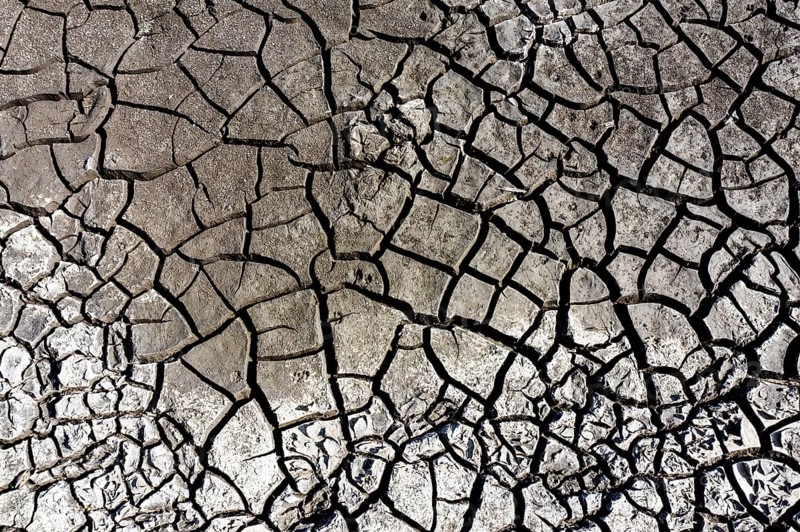 The bottom of a dried-up fish pond in Reckahn in Brandenburg looks like parched desert soil. The Plane, a river that usually fills the fish ponds with water, is dry and no longer carries any water, Reckahn, 09/08/2022