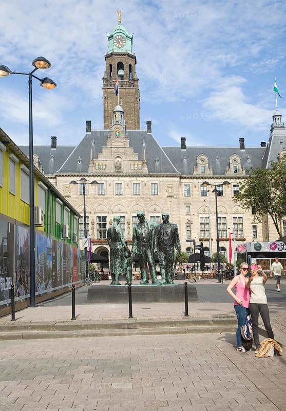 Historic Stadhuis building Rotterdam, Netherlands constructed 1920 with Mari Andriessen's Memorial to the Fallen 1940-1945 – four bronze figures – from 1957 commemorates the victims of the Second World War