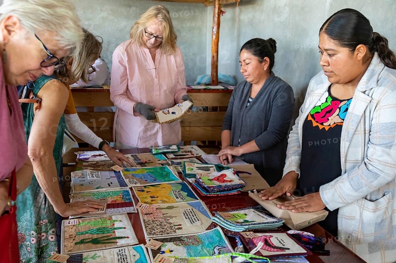 Tanivet, Oaxaca, Mexico, Virtually all the men in this small village have left for the United States to find work. The women who remain have formed an artist coooperative, embroidering the story of their separation. They call themselves Las Hormigas Bordadoras de Tanivet (embroidering ants) . Tourists visited to view and purchase their work, Central America