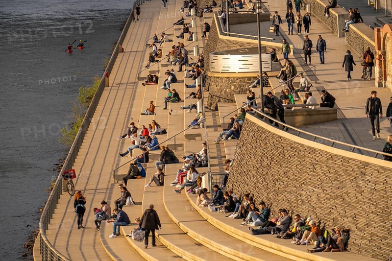 Rhine promenade, Rhine boulevard, on the Deutzer Ufer, people sitting in the spring sun on the Rhine, Cologne North Rhine-Westphalia, Germany, Europe