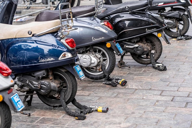Scooter, locked with thick steel chains, car park in the city centre of The Hague, Netherlands