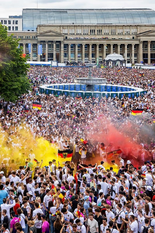 UEFA European Football Championship. Enthusiastic fans with pyrotechnics, public viewing in the host city of Stuttgart under the motto: the whole city is one stadium. 30, 000 football fans with German flags on the Königsbau on Schlossplatz in Stuttgart, Baden-Württemberg, Germany, Europe