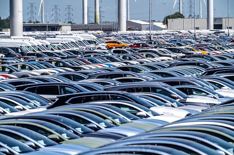 Storage area for new cars in the port of Vlissingen-Oost, vehicles are temporarily stored on over 100 hectares to ship them from Europe to the United Kingdom, Ford cars, others such as models from the Chinese car manufacturer BYD are delivered from here in Europe, wind farm, Netherlands