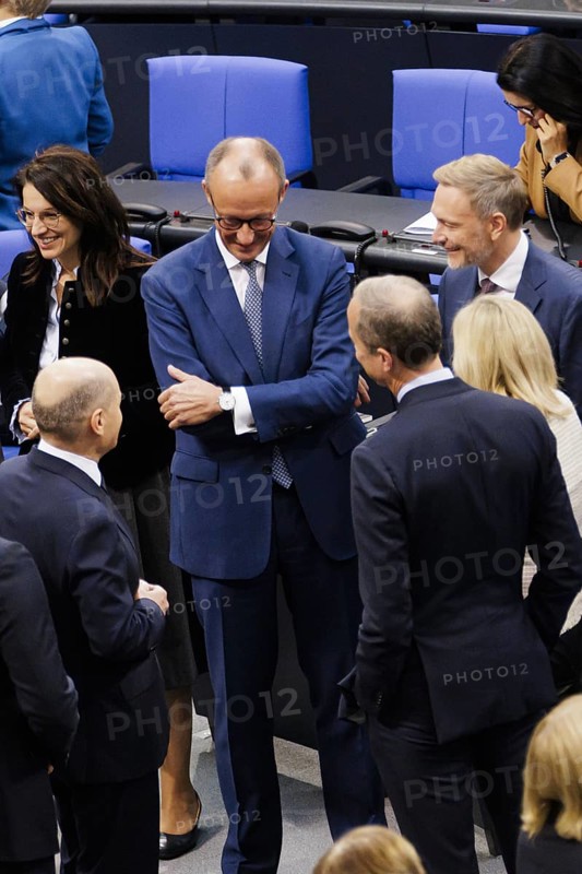 Olaf Scholz (SPD), Federal Chancellor, greets Friedrich Merz, CDU, and Christian Lindner in plenary in front of the session in the German Bundestag, Berlin, 13 November 2024