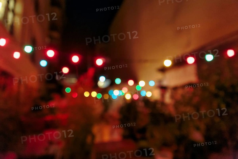Bokeh balls, colourful string of lights on roof terrace, night shot, Gracia, Barcelona, Spain, Europe