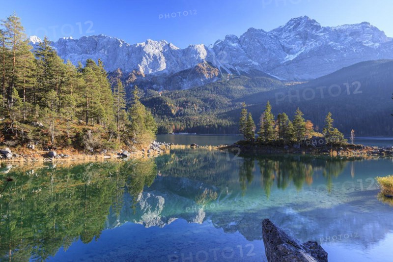Steep mountains reflected in lake, evening light, autumn, Eibsee lake, Zugspitze, Bavaria, Germany, Europe