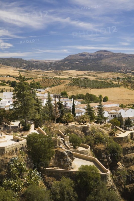 High angle view of residential buildings and valley with agricultural lands and mountains, Ronda, Spain, Europe