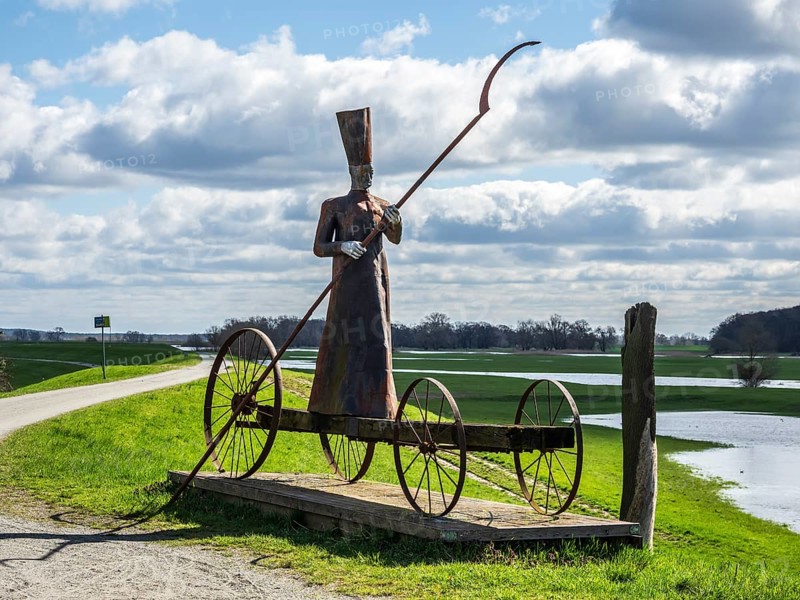 Sculpture on dike at River Elbe, Mödlich, ferryman bringing people to the world of death, Germany, Europe