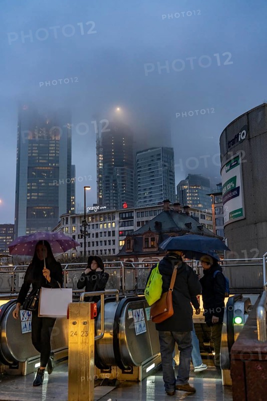 Rainy weather, freezing rain, entrance to Hauptwache underground station, high-rise skyline in clouds, passers-by hurrying through the damp, icy weather, Frankfurt am Main, Hesse, Germany, Europe