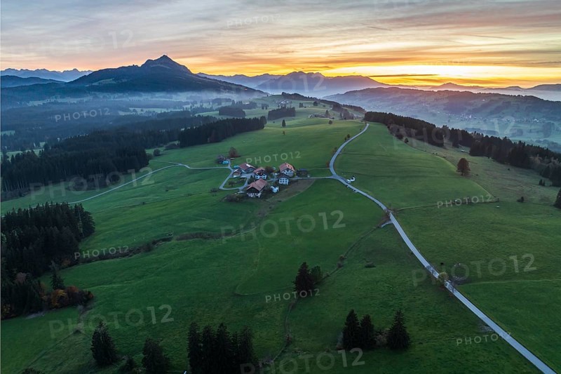 Mountain range near village Wertach, view to mt. Gruenten, sunset, fog in valley, traditional farm, aerial view, Allgaeu, Bavaria, Germany, Europe