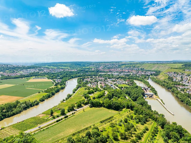 Hilly landscape with wide fields and a meandering river under a blue sky, with a small village on its banks, Besigheim, Germany, Europe