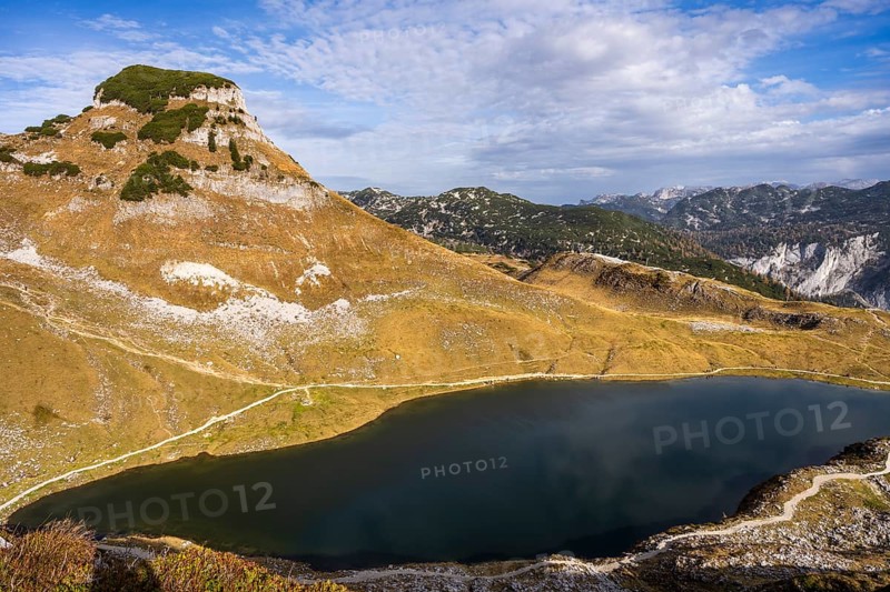 Lake Augstsee and the Atterkogel mountain on the Loser. View of other mountains. Autumn, good weather, blue sky and clouds. Altaussee, Bad Aussee, Ausseer Land, Totes Gebirge, Styria, Upper Austria, Austria, Europe