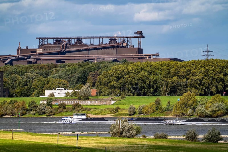 Rhine at Duisburg-Beeckerwerth, freighter loaded with coal, Oxygen steelworks 2 Industrial backdrop of the ThyssenKrupp Steel steelworks in Bruckhausen, North Rhine-Westphalia, Germany, Europe