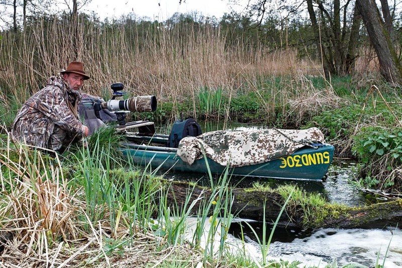 A canoe with camouflaged camera in a swamp, surrounded by vegetation and quiet nature, boat of a nature photographer, working method of a nature photographer, Naturpark Flusslandschaft Peenetal, Mecklenburg-Vorpommern, Germany, Europe