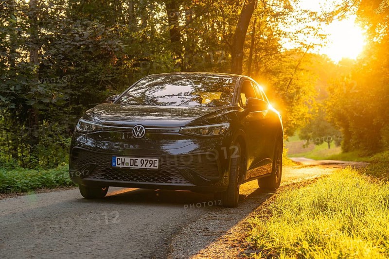 Car on a road in the forest in the evening light of the sunset, electric car, VW ID5, Gechingen, Black Forest, Germany, Europe