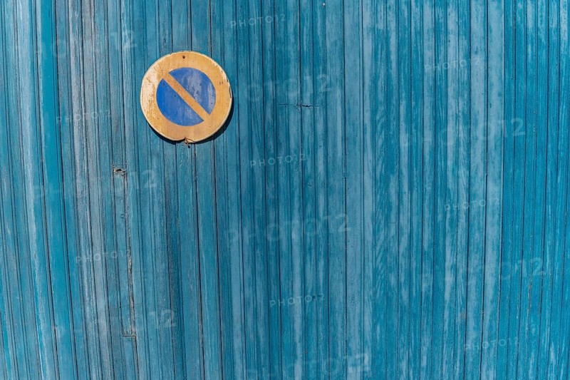 Garage door boards stained blue with worn paint. Brittany France
