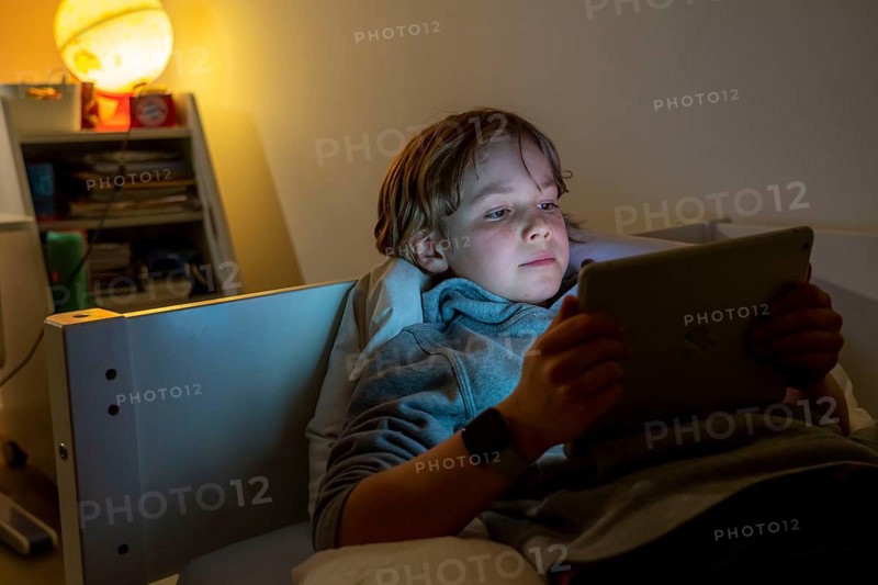 A boy plays computer games on a tablet PC