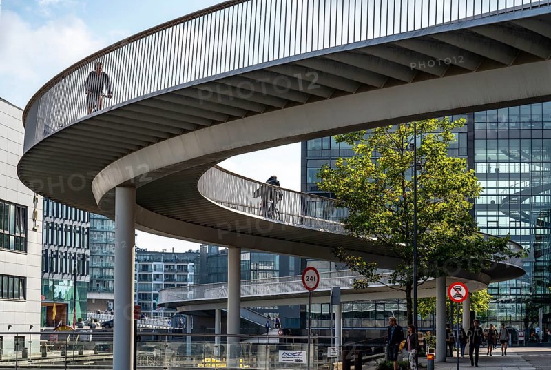 Cyclists on the Cykelslangen cycle and pedestrian bridge, at the Fisketorvet shopping centre, across the harbour, Sydhavnen, Copenhagen is considered the cycling capital of the world, 45 % of the population travel by bike, Denmark, Europe