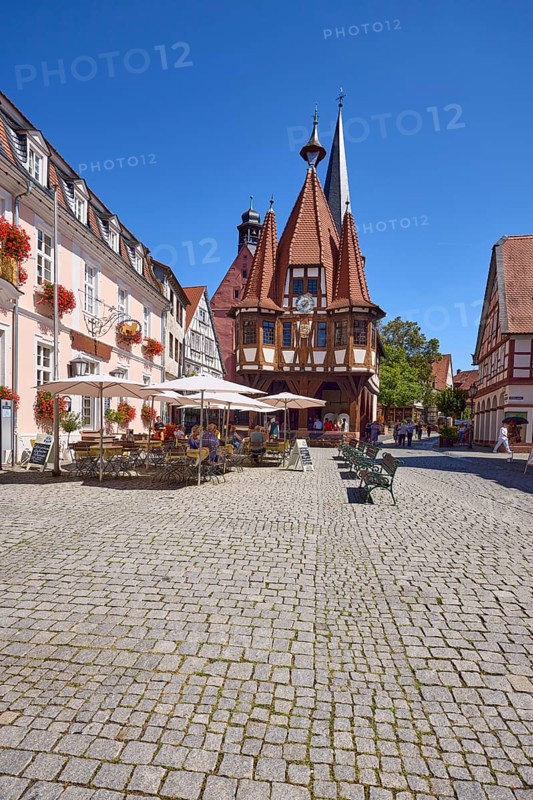 Historic town hall with outdoor area of the confectionery and café Leyhausen under a cloudless blue sky on the market square in Michelstadt, Odenwald, Odenwaldkreis, Hesse, Germany, Europe