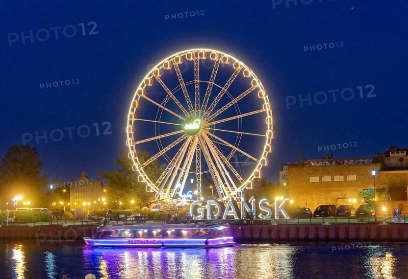 The Ferris wheel illuminated in the evening on the Motlawa, Motlawa, and the lettering Gdansk, Danzig, in the harbour district of Danzig. Gdansk, Pomerania, Poland, Europe