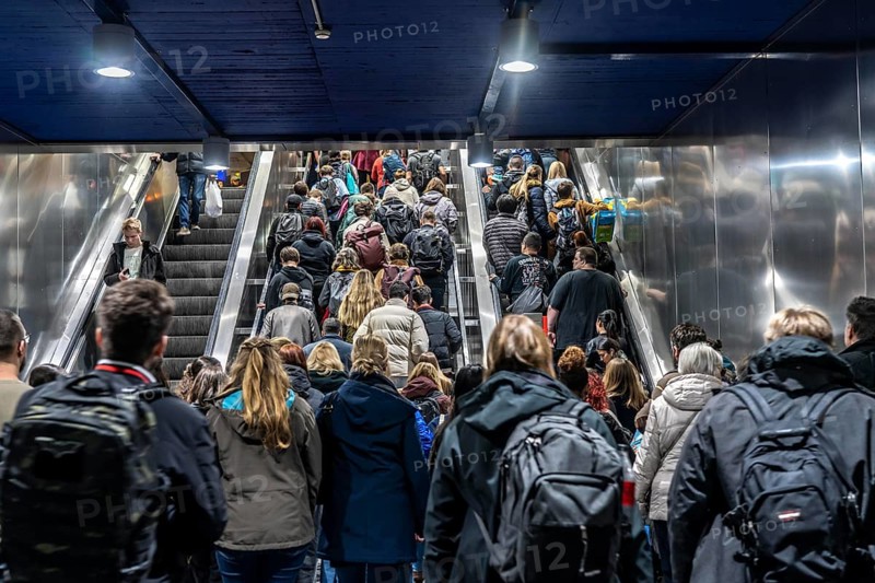 Public transport, underground, main station exit, many people crowding out of the underground station at rush hour in the afternoon, via stairs and escalators, North Rhine-Westphalia, Germany, Europe