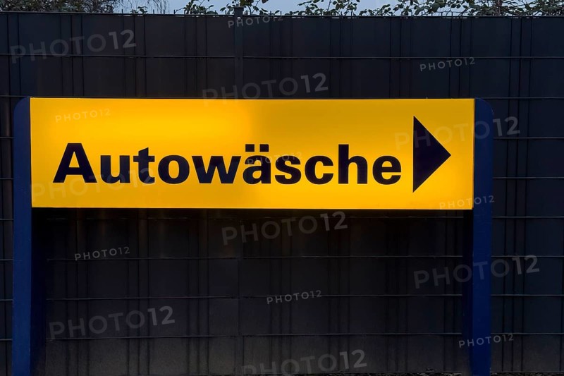 Illuminated sign with inscription car wash and directional arrow, Germany, Europe