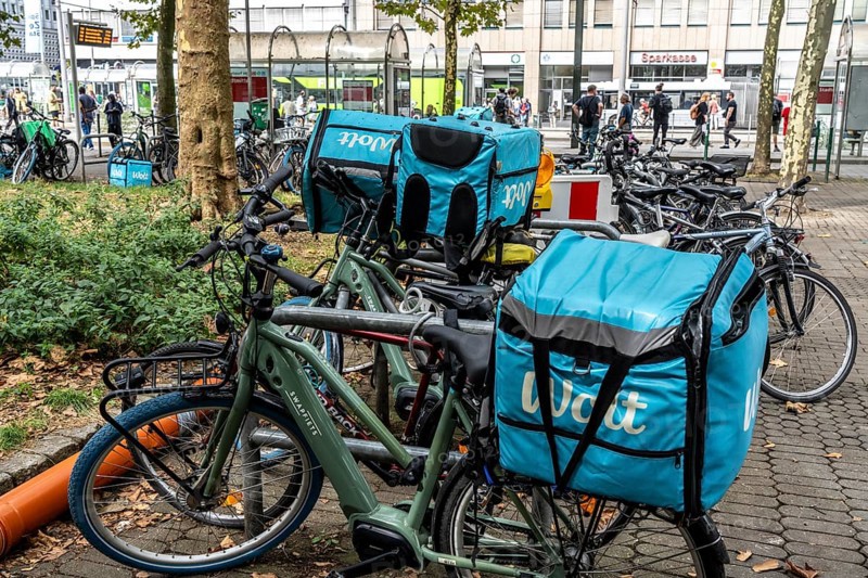 Wolt delivery service, parked bikes of bicycle couriers with thermal backpack, in front of the main railway station in Düsseldorf, North Rhine-Westphalia, Germany, Europe