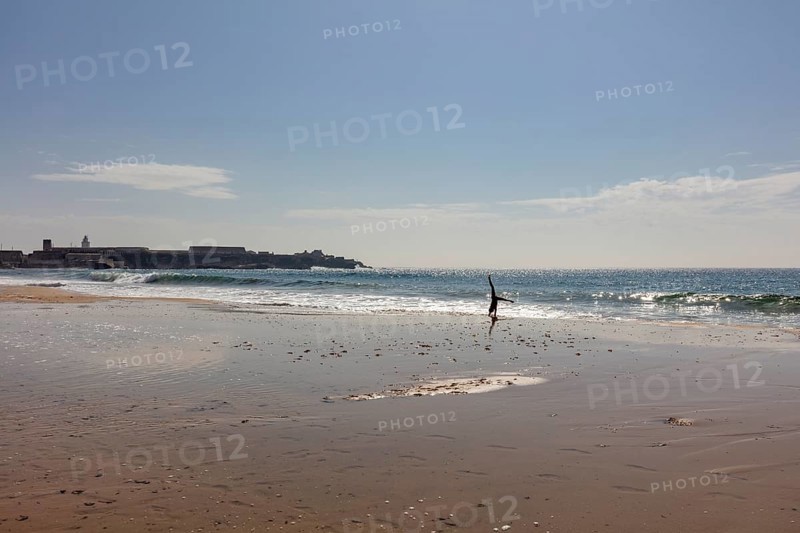 Lonely beach with breaking waves under a sunny sky, Tarifa