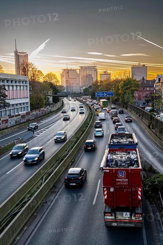 Evening traffic, partly with traffic jams, slow-moving traffic on the A40 motorway, skyline of Essen, RWE tower on the left, Evonik Group headquarters in the middle, former Postbank building on the right, Essen, North Rhine-Westphalia, Germany, Europe