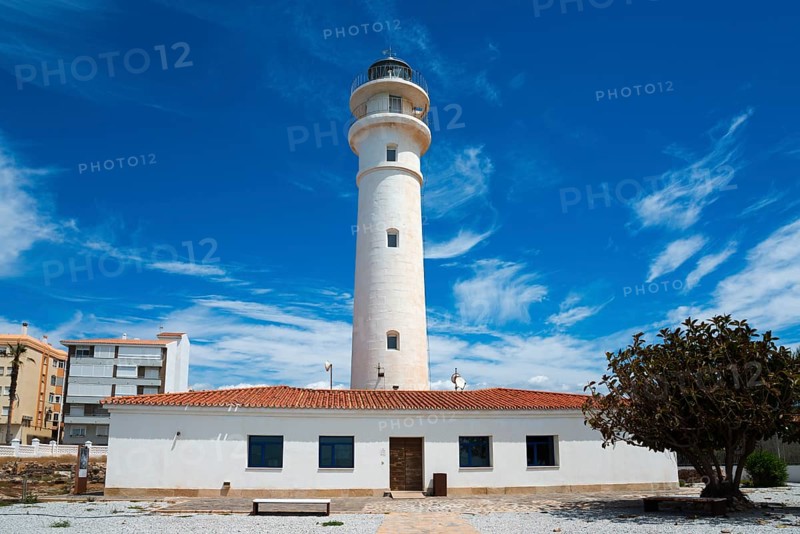 White lighthouse with neighbouring building under blue sky with clouds, sunny atmosphere, Faro de Torrox, Torrox, Málaga province, Malaga, Andalusia, Spain, Europe