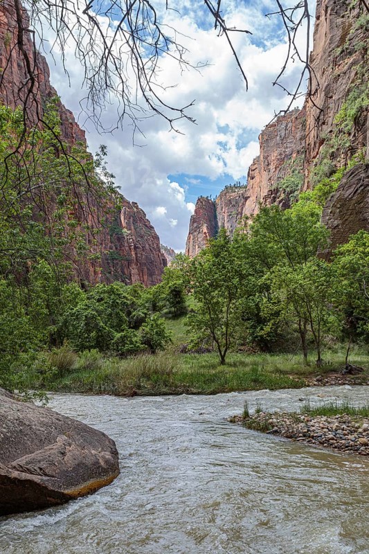 Virgin River runs between sandstone rock formations along the Riverside Walk in the Temple of Sinawava area of Zion National Park, Utah