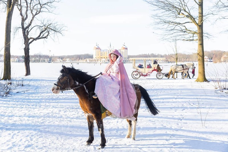 This year, the most popular fairytale film of all time is celebrating a special anniversary. At Moritzburg Castle, one of the film's locations, the exhibition on the cult film Three Hazelnuts for Cinderella is opening for the twelfth time - with an anniversary-worthy supporting programme and special exhibition. Model Tamara Kretschmer once again slipped into the coveted role of the legendary Cinderella with the ball gown. Here she rides the legendary film horse Catano, Moritzburg, Saxony, Germany, Europe