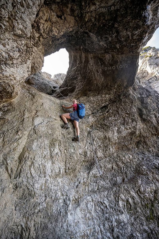 Hiker climbing through the Schindertor, Schinder, Tegernsee mountains in the Mangfall mountains, Germany, Europe