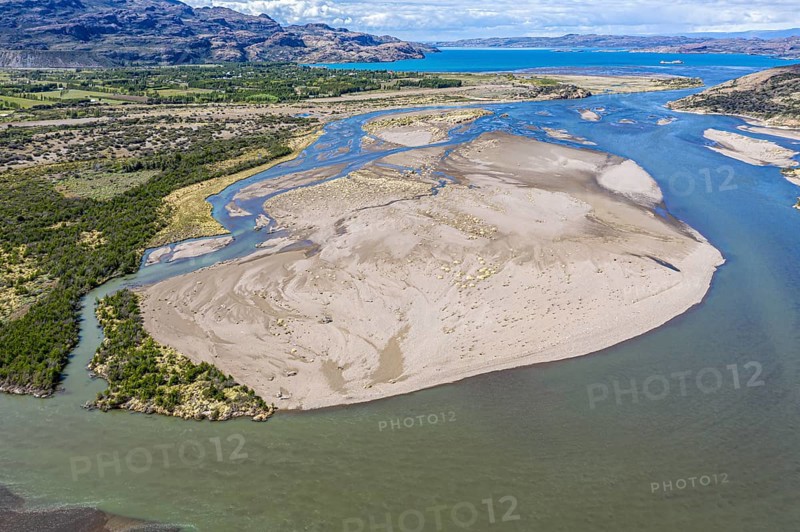 Sandbank in the river Rio Ibanez short before flowing into lake Lago General Carrera, new vegetation starts to grow on the island, Patagonia, Chile, South America