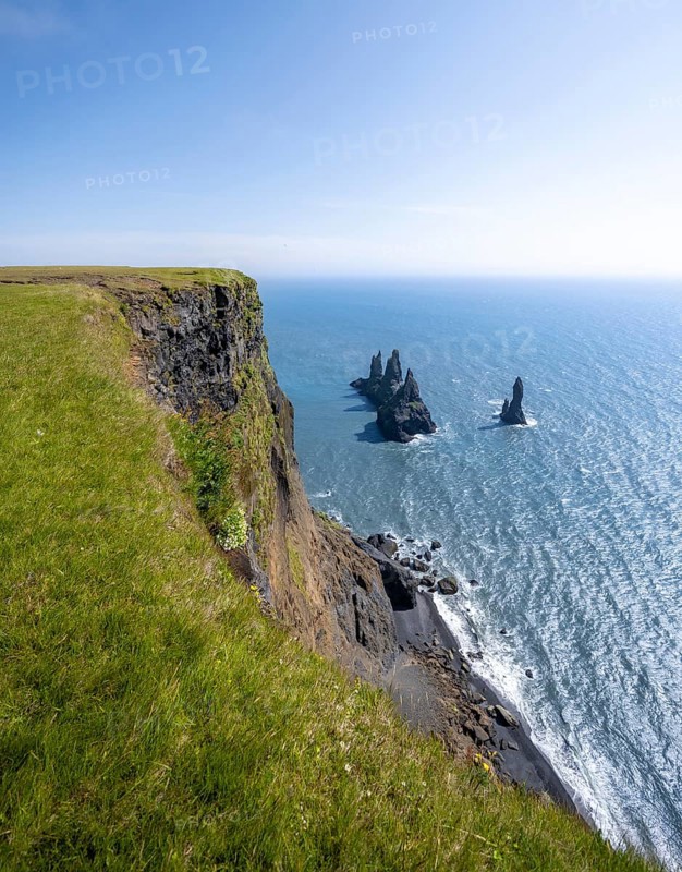 Steep coast, view from steep cliff to the rocks Reynisdrangar in the water, at Reynisfjara beach, Vik, South Iceland, Iceland, Europe