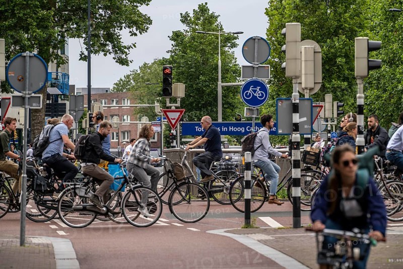 Central cycle path at Catharijnesingel, in the city centre of Utrecht, lanes for pedestrians, cyclists and cars are separated, waiting at traffic lights, heavy traffic, Netherlands