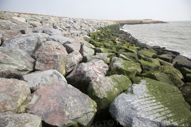 Coastal erosion and management, East Lane, Bawdsey, Suffolk, England. The new rock armour defences and massive engineering work undertaken in 2009 have been paid for through an Innovative scheme under which local farmers have donated land to be sold land for housing to pay for coastal defences. Bawdsey, Suffolk, England