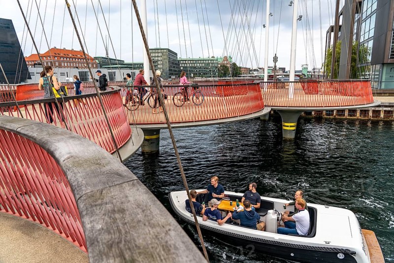 Cyclists on the Cirkelbroen cycle and pedestrian bridge, over the harbour, in the Christianshavens district, Copenhagen is considered the cycling capital of the world, 45 % of the population travel by bike, Denmark, Europe