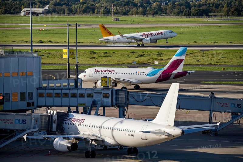 Düsseldorf Airport, Pegasus Airline, Airbus A321neo on approach, Eurowings Airbus on the taxiway for take-off, and at Terminal A
