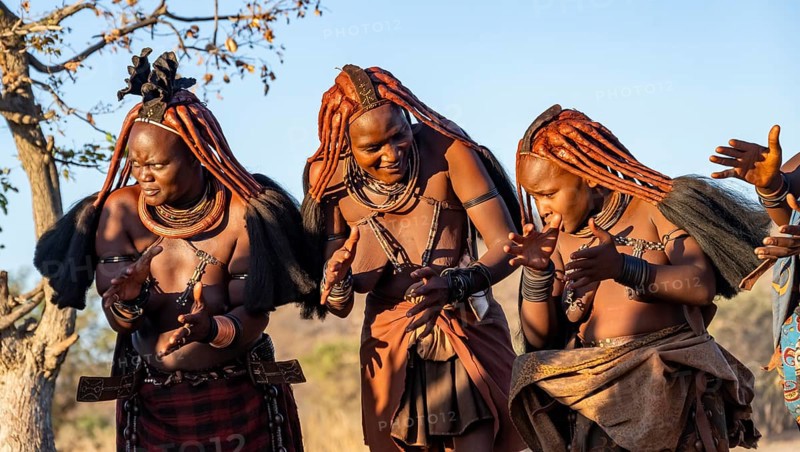 Traditional Himba woman clapping, music and dance, portraits, in the evening light, near Opuwo, Kaokoveld, Kunene, Namibia, Africa