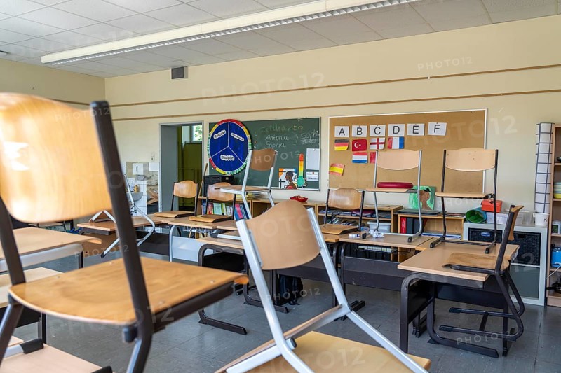 Classroom of a fourth grade, after school, the building is older but in good condition, modern teaching materials
