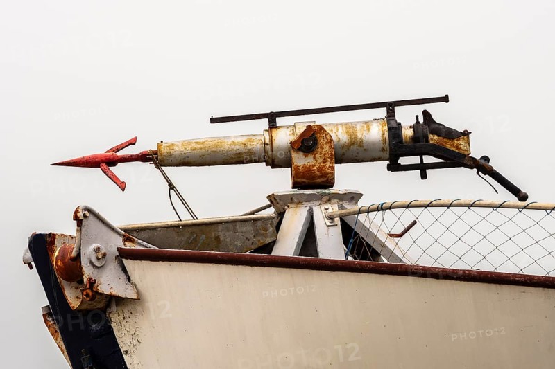 Gun with harpoon on former whale hunting boat converted to a restaurant, Tranoya, northern Norway south of Narvik