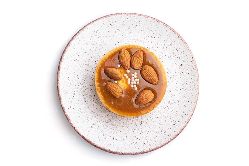 Sweet tartlets with almonds and caramel cream isolated on white background. top view, flat lay, close up