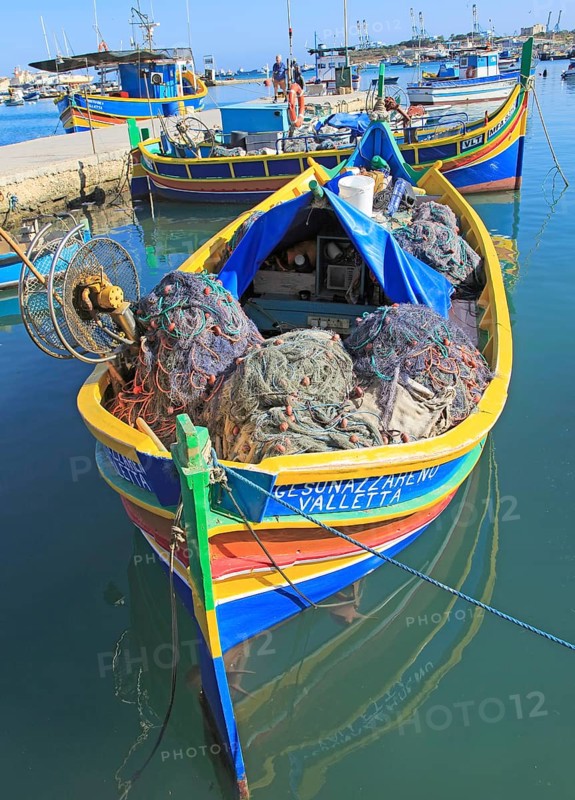 Colourful traditional fishing boats called luzzu in the harbour at Marsaxlokk, Malta, Europe