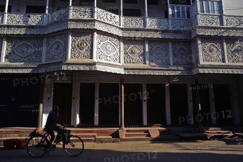 Cyclist in front of a ornate house, street scene at Daltonganj, Jharkhand, India, Asia