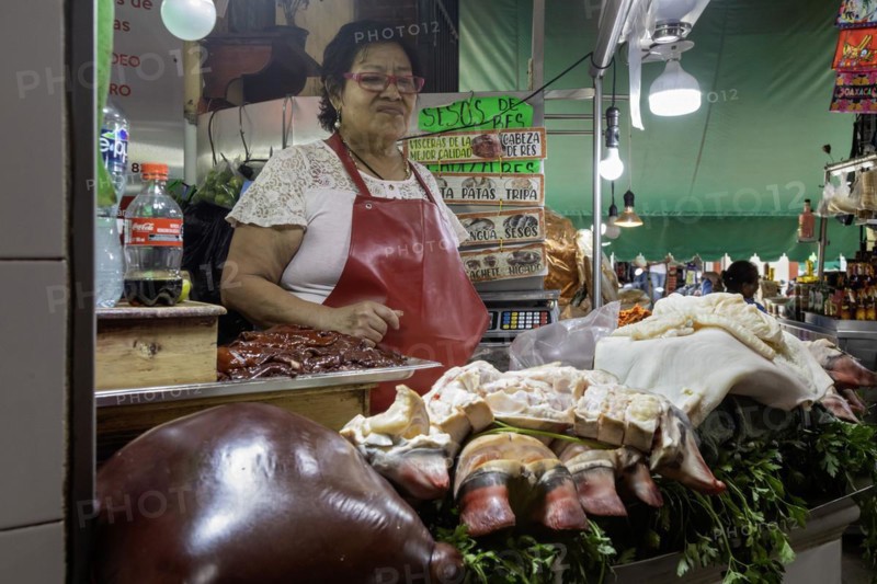 Oaxaca, Mexico, A vendor sells liver, bull's feet, and other meats at the Benito Juarez Market. Opened in 1894, it is one of the largest and oldest markets in Oaxaca. Its many dozen stalls sell food of every kind, clothing, souvenirs, and more, Central America