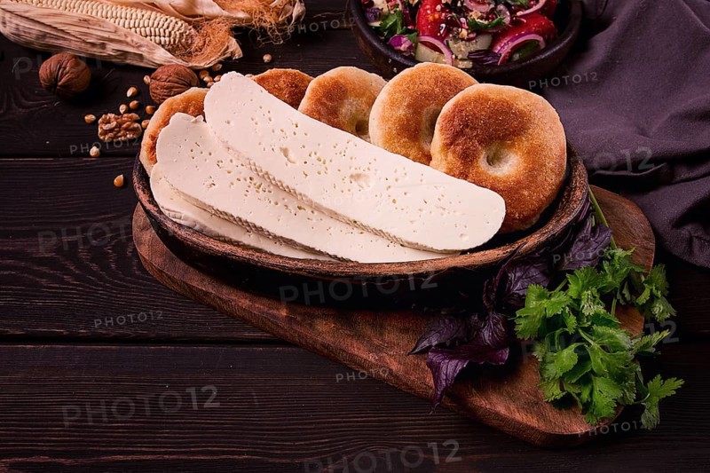 Mchadi, corn tortillas, traditional Georgian dish, corn bread, with Imeretian cheese, homemade, no people, on a wooden table