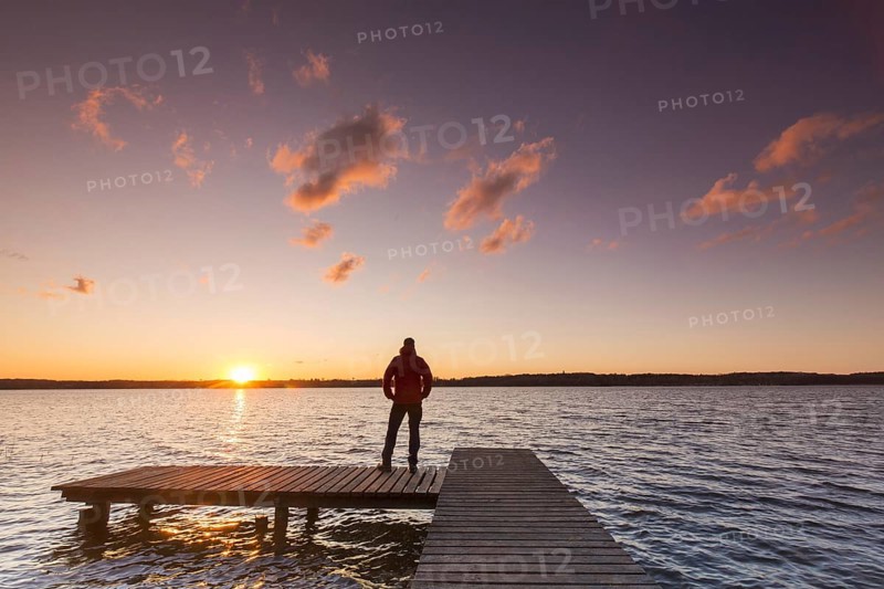 Man on jetty at Lake Ratzeburg, Ratzeburger See at Lauenburg Lakes Nature Park, Naturpark Lauenburgische Seen, Schleswig-Holstein, Germany, Europe